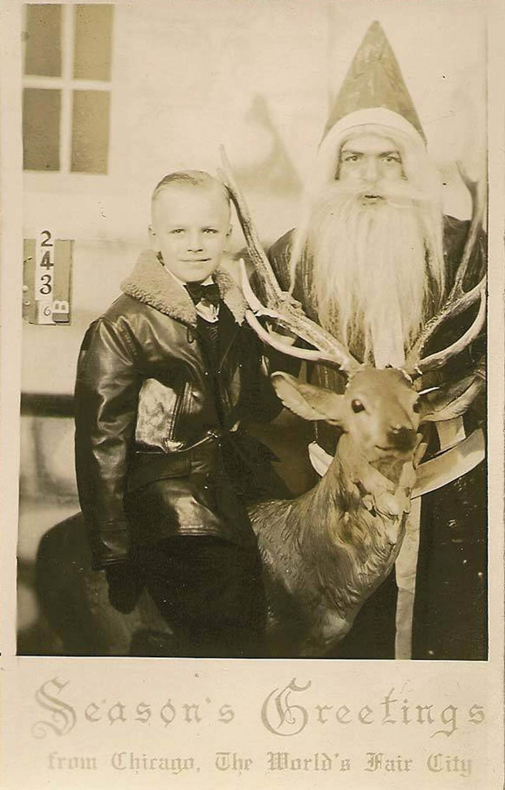 Boy with Santa Claus and reindeer, Season's Greetings postcard — vintage postcard