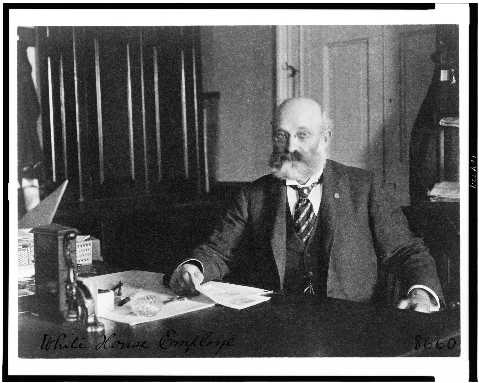 [Col. William H. Crook, a White House employee, half-length protrait, seated at desk, facing left], [between 1890 and 1910] — historic photograph