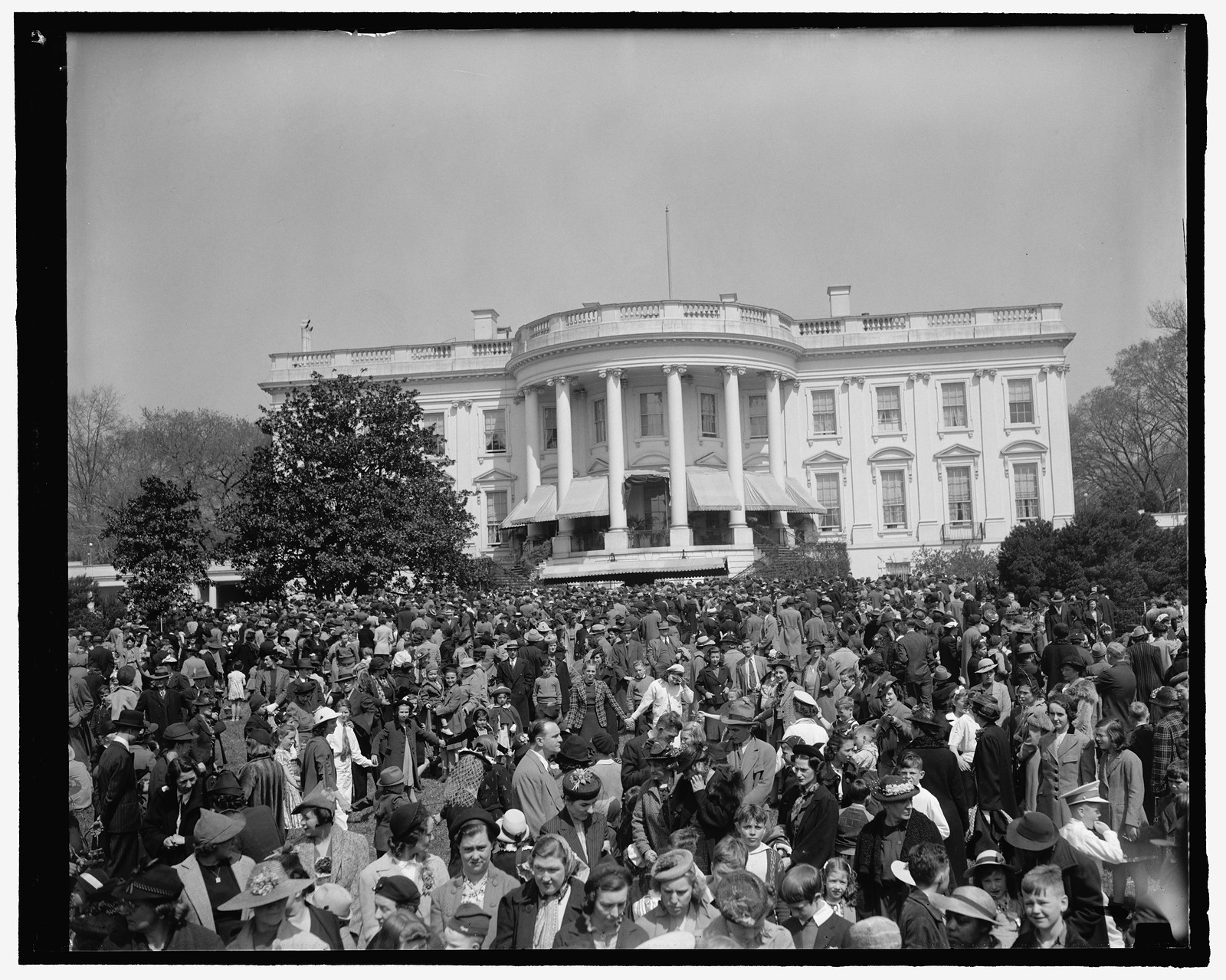 Youngsters jam White House lawn to roll Easter eggs. Washington, D.C., April 10. General view of the thousands of Youngsters who today took part in the traditional Easter egg rolling on the historic White House lawn. President and Mrs. Roosevelt greeted the children from the south portico. 4-10-39, 1939 April 10. — historic photograph