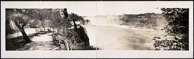 Panoramic photograph of Niagara Falls from a railed overlook path