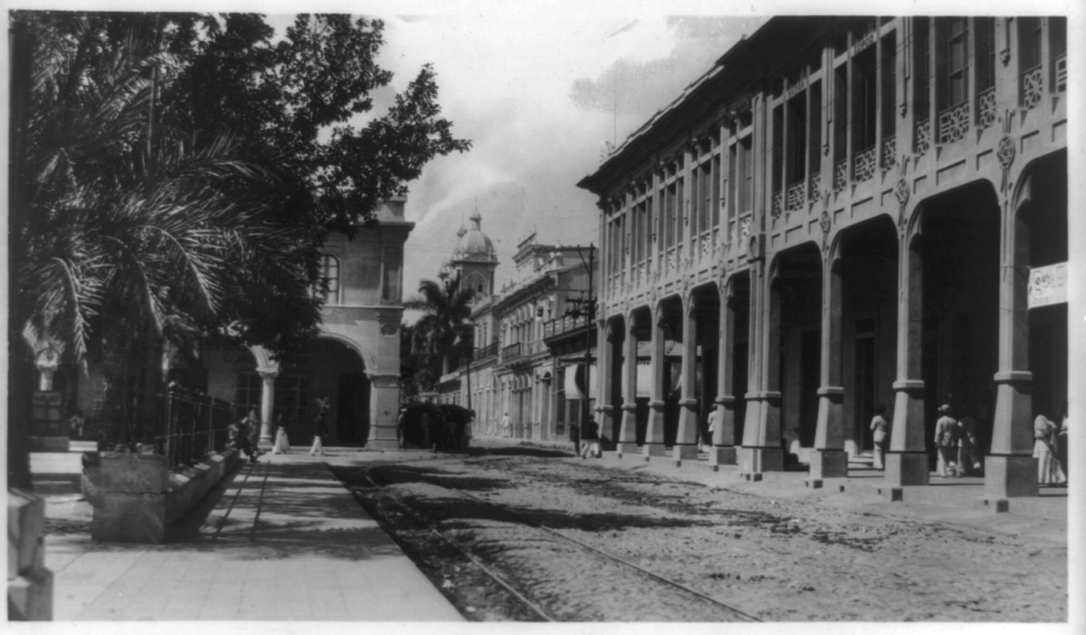 [One of the modern concrete business buildings facing a central park, San Salvador, El Salvador], [ca. 1917] — vintage postcard