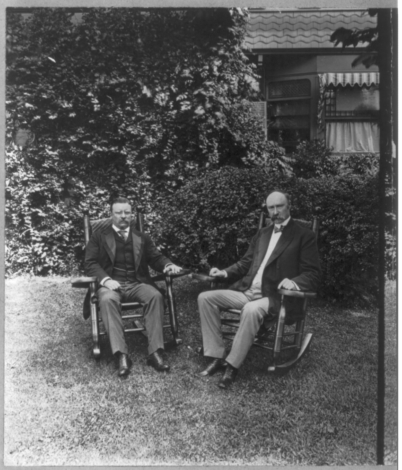 [Theodore Roosevelt, full length, seated in chair on lawn, facing slightly right, with Senator Charles Warren Fairbanks, at Sagamore Hill, Oyster Bay, N.Y.], c1904. — historic photograph