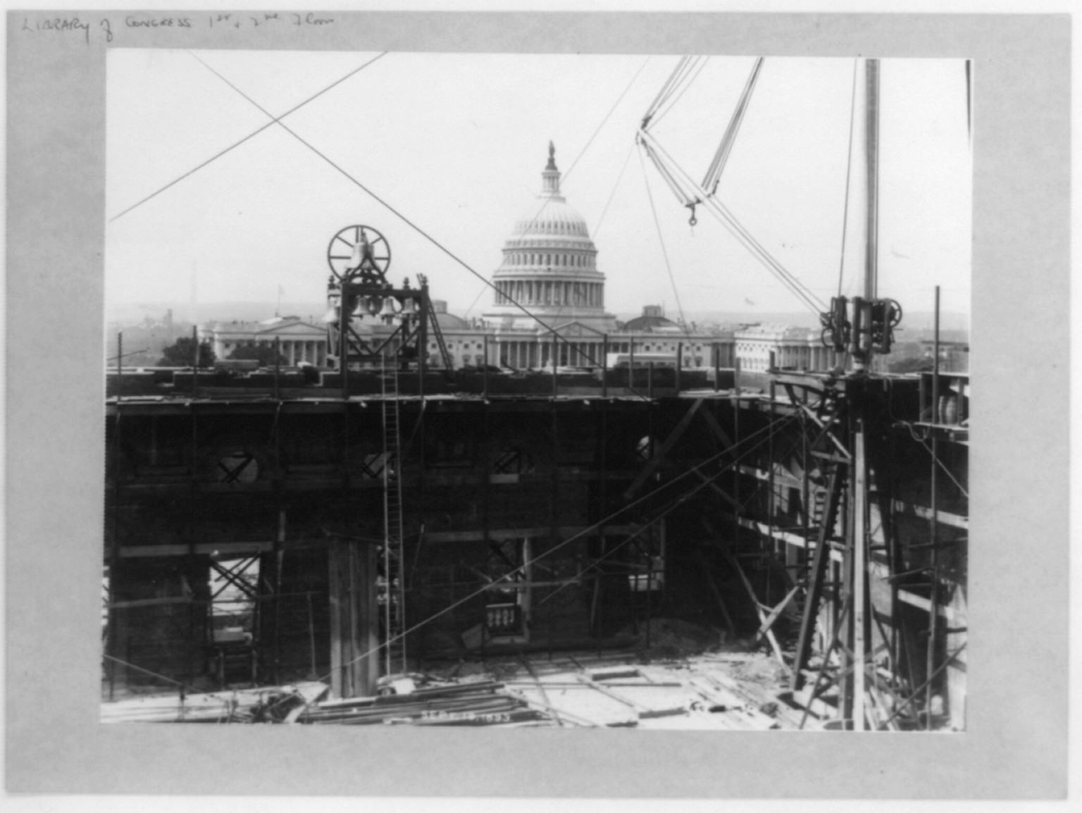 [D.C.-Wash.-Library of Congress - official construction photos: Capitol dome viewed across bells and construction area], [no date recorded on caption card] — historic photograph