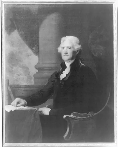 [Thomas Jefferson, three-quarter length portrait, seated at table, facing left]