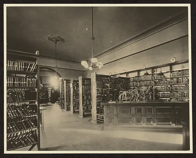 Library interior with bookshelves and a wooden reading desk