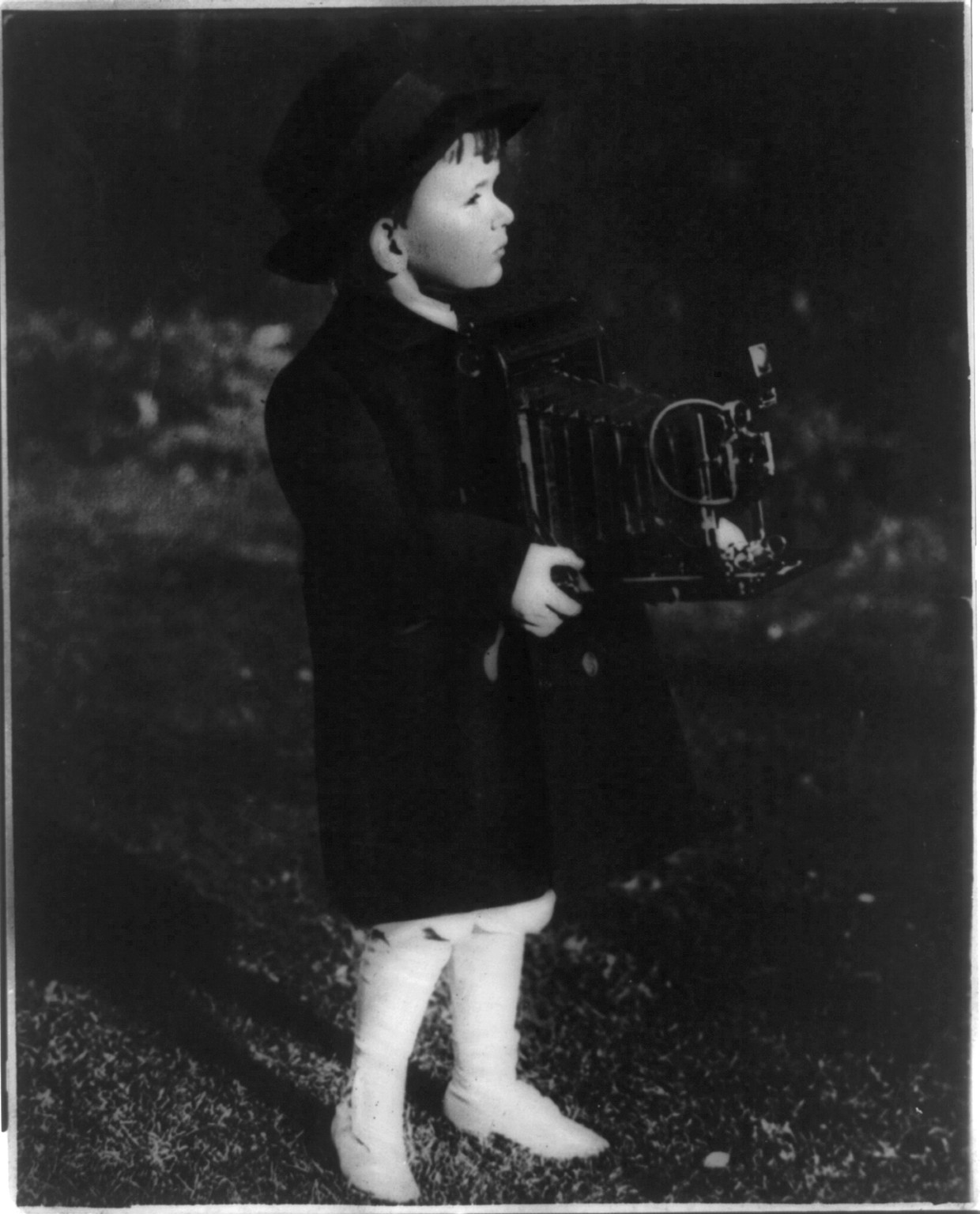 [Small boy with large camera] — historic photograph