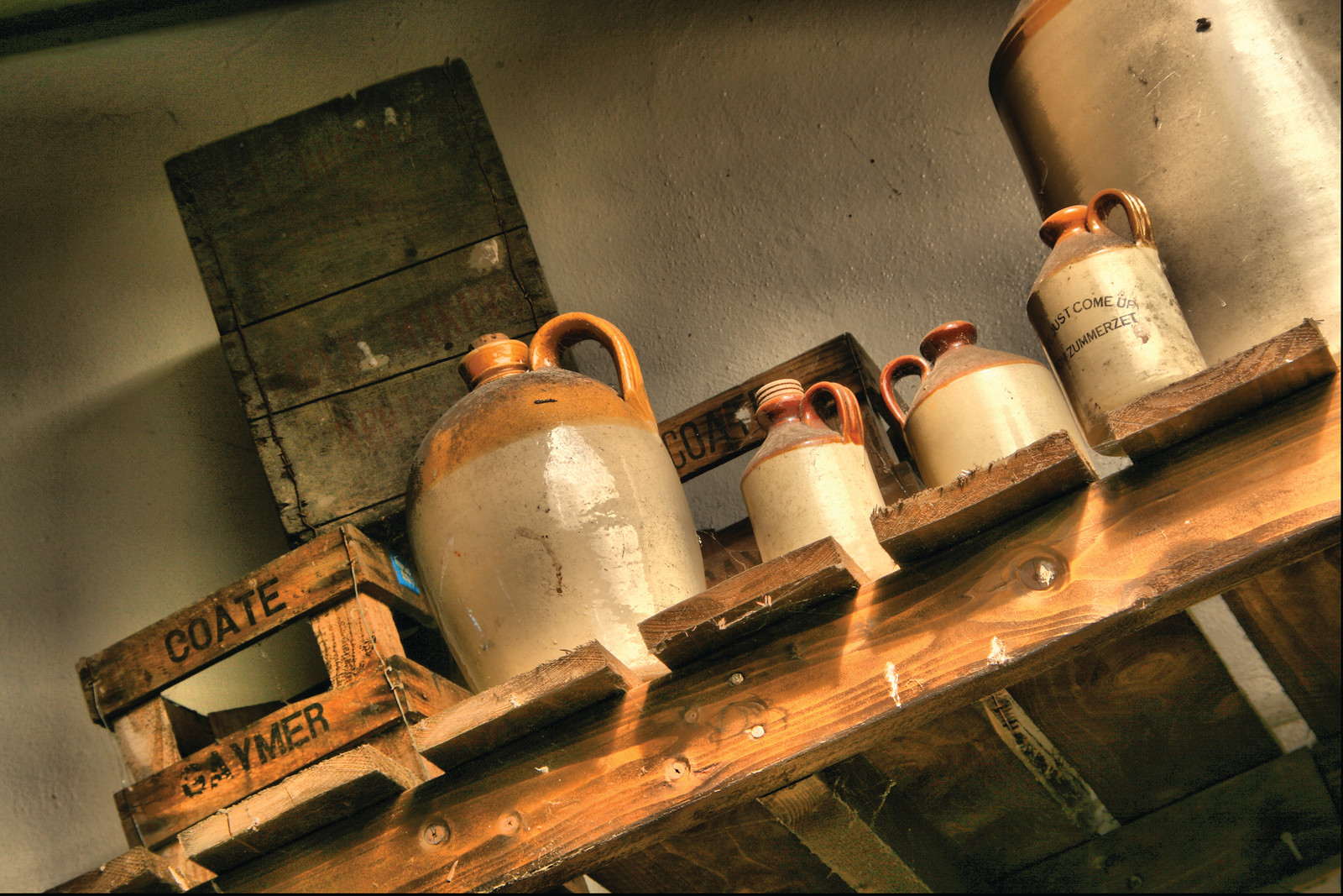 Stoneware jugs and labelled crates on a wooden shelf — historic image