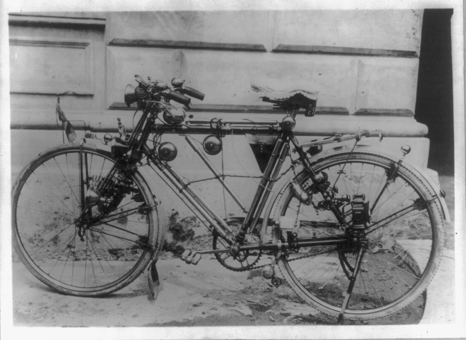 [A bicycle with 15 bells on it, 10 lights, 6 tire pumps, an embroidered seat cover and other gadgets, Bangkok, Siam] — historic photograph
