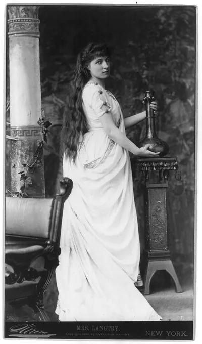 [Lillie Langtry, 1853-1929, full-length portrait, standing, facing right, holding vase on stand]