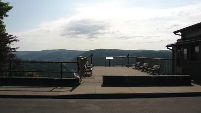 Overlook platform with benches above wooded hills