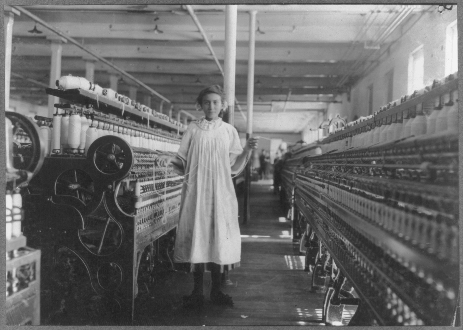 Mamie La Barge at her Machine. Under legal age. Location: Winchendon, Massachusetts., 1911 September. — historic photograph