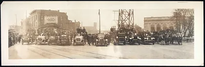 Firemen with cars and horse-drawn fire wagons on a city street