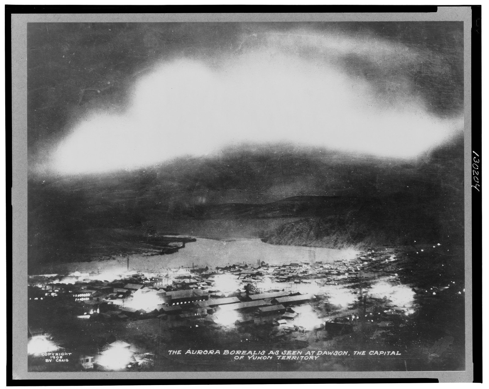 The aurora borealis as seen at Dawson, the capitol of Yukon Territory, c1908. — historic photograph