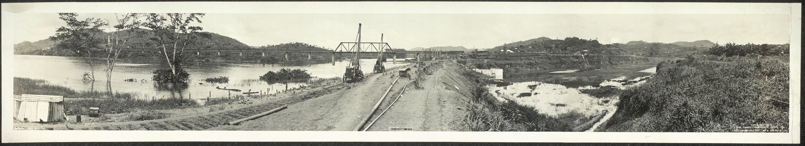 Panoramic photograph of Panama Canal works with railway embankment and bridge — historic photograph