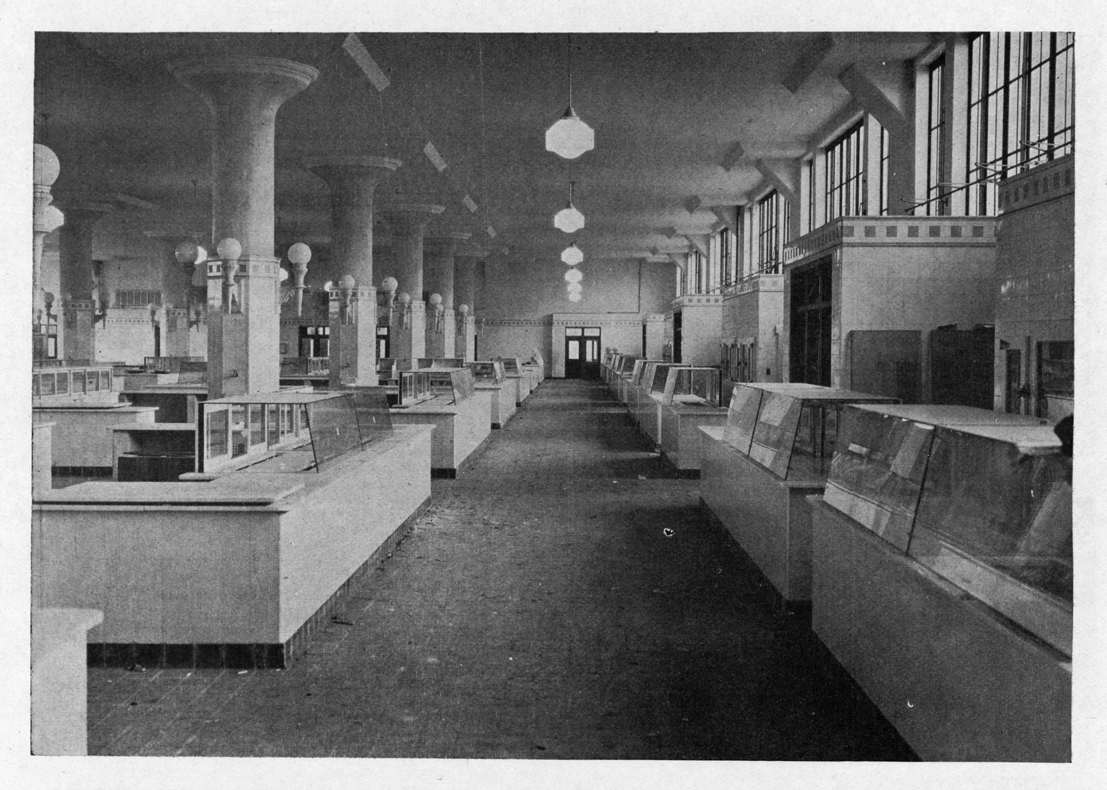 Interior of a market hall with glass display counters — historic image