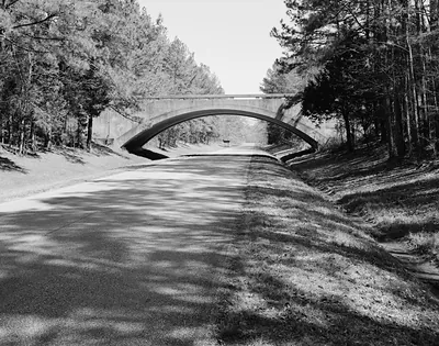 Concrete arch bridge over a parkway road