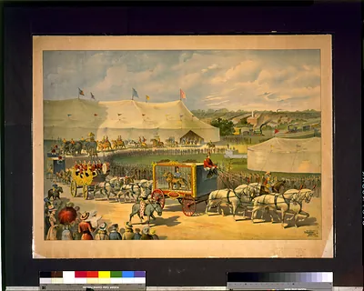 [Parade with lion in cage on wagon, circus tent in background]