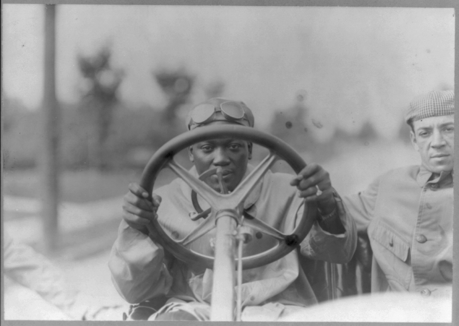 [Jack Johnson - behind wheel of auto] — historic photograph