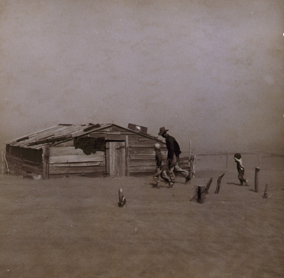 Farmer and sons walking in the face of a dust storm. Cimarron County, Oklahoma, 1936 Apr. — historic photograph