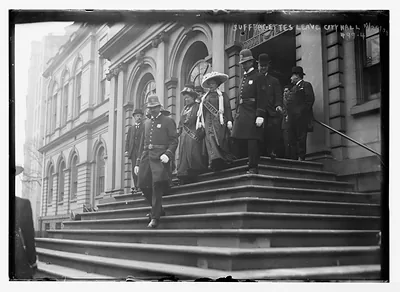 Suffragettes, preceded by policemen, decend steps of City Hall, New York