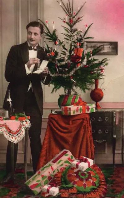 Man in evening dress beside a decorated Christmas tree