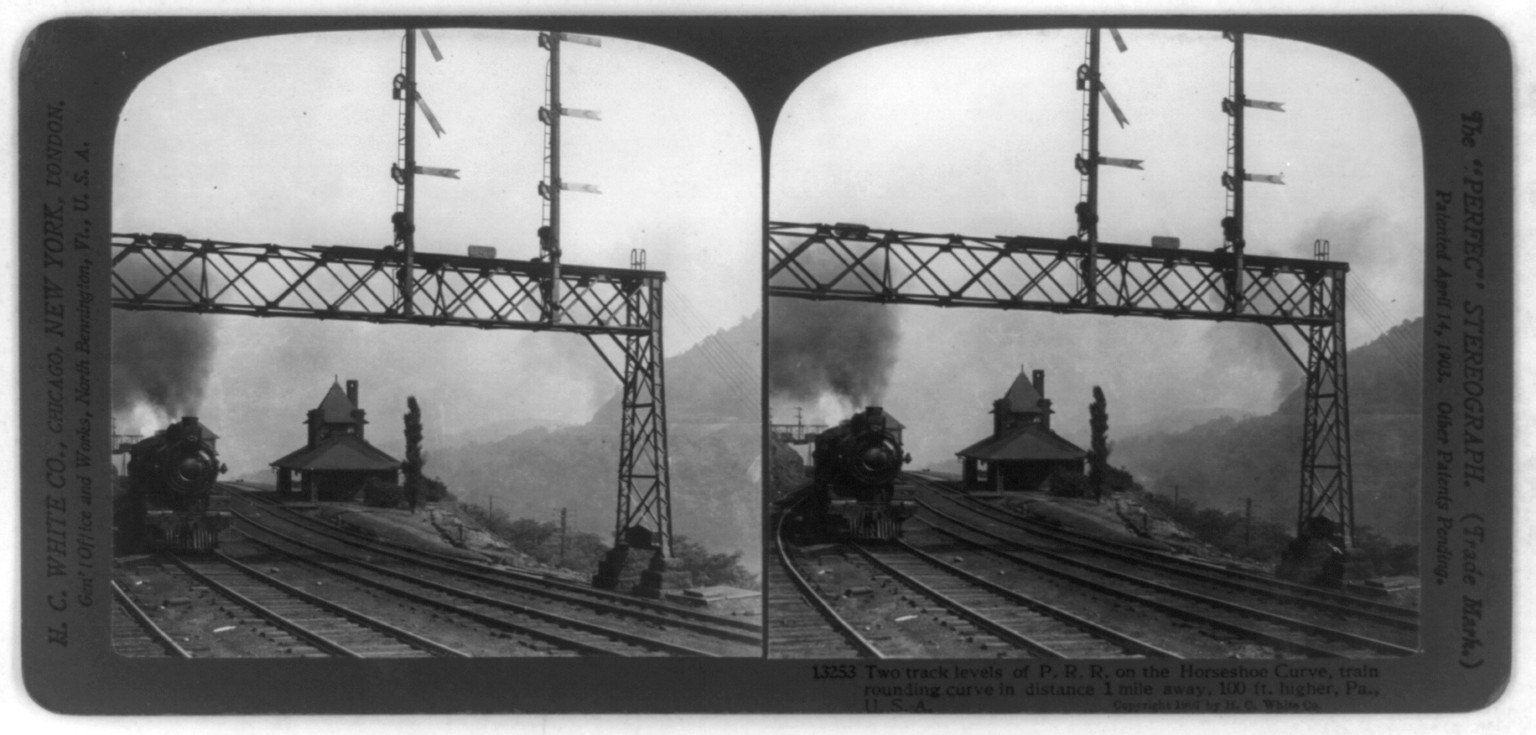 Two track levels of P.R.R. on the horseshoe curve, train rounding curve in distance 1 mile away, 100 ft. higher, Pa., U.S.A., Chicago : H.C. White Co., c1907. — stereograph