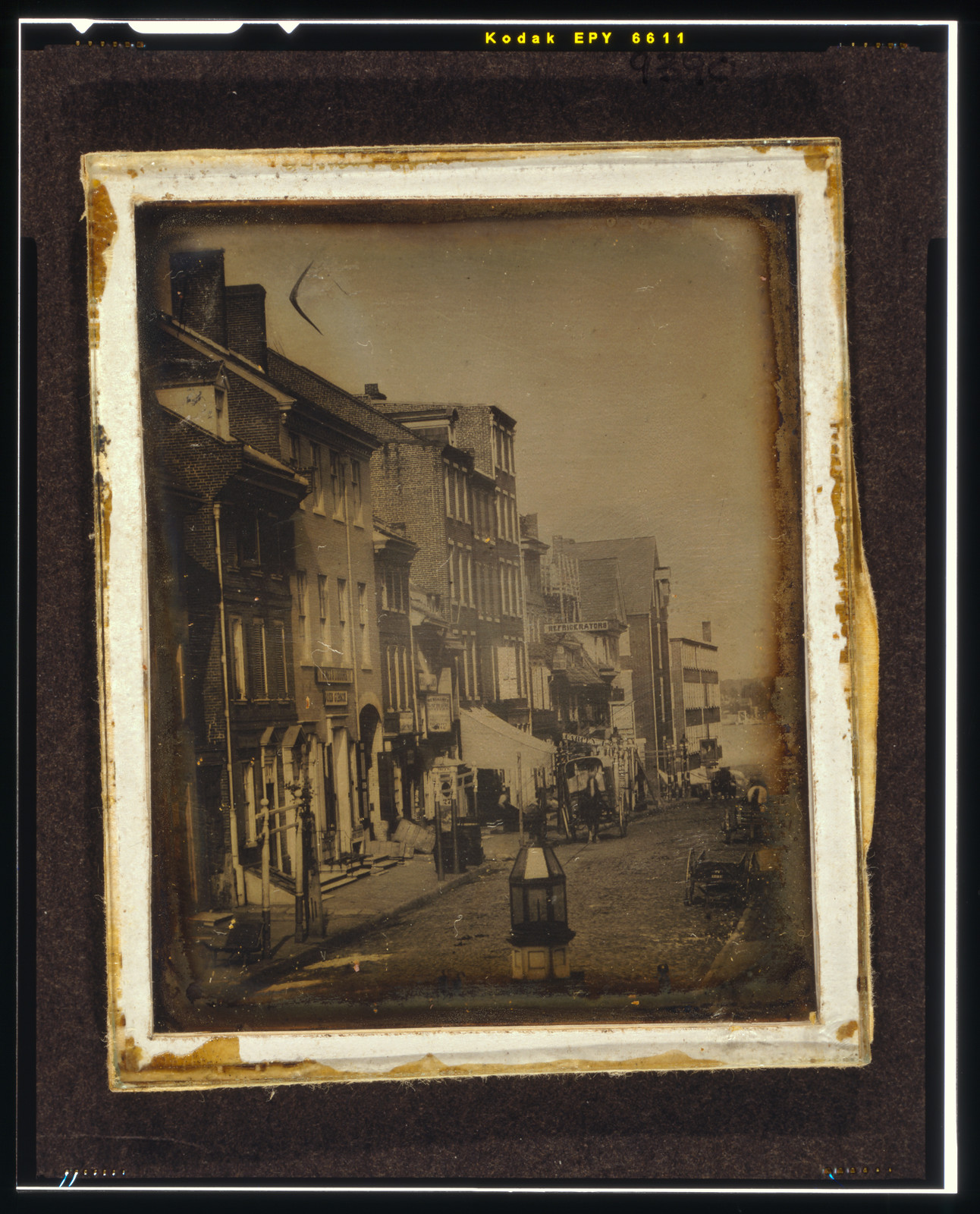 Daguerreotype of a city street with shops and carriages, 1842 — historic photograph
