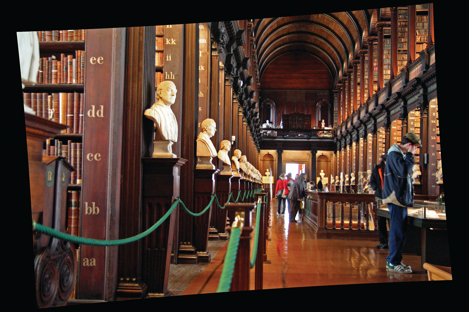 Long Room library with marble busts behind a green rope — historic image