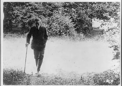 Ex-Kaiser Wilhelm II of Germany walking alone on his estate, with cane in hand