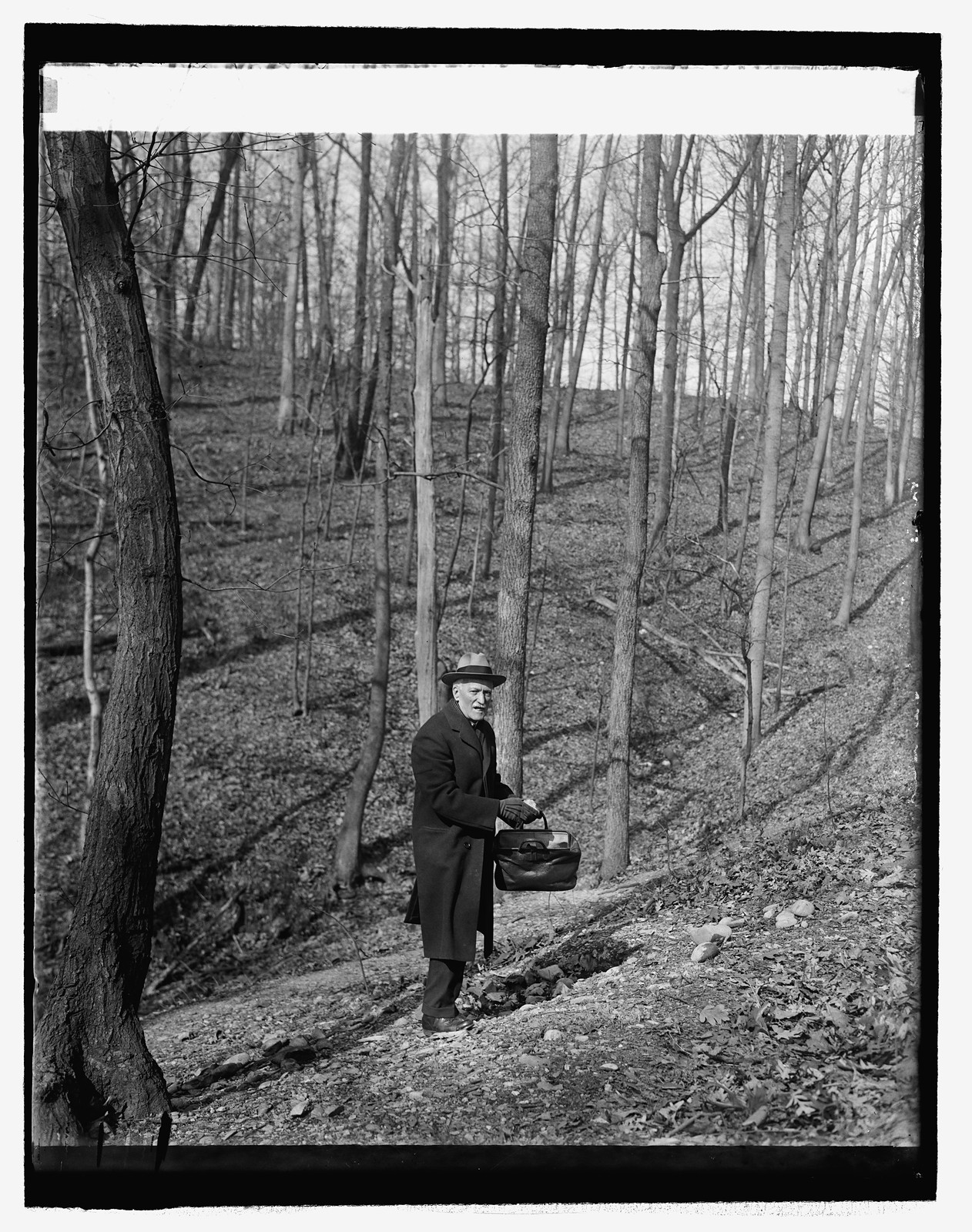 Dr. Walter Hough of Smithsonian in arrowhead quarry (Rock Creek Park), 3/6/26, [19]26 March 6. — historic photograph