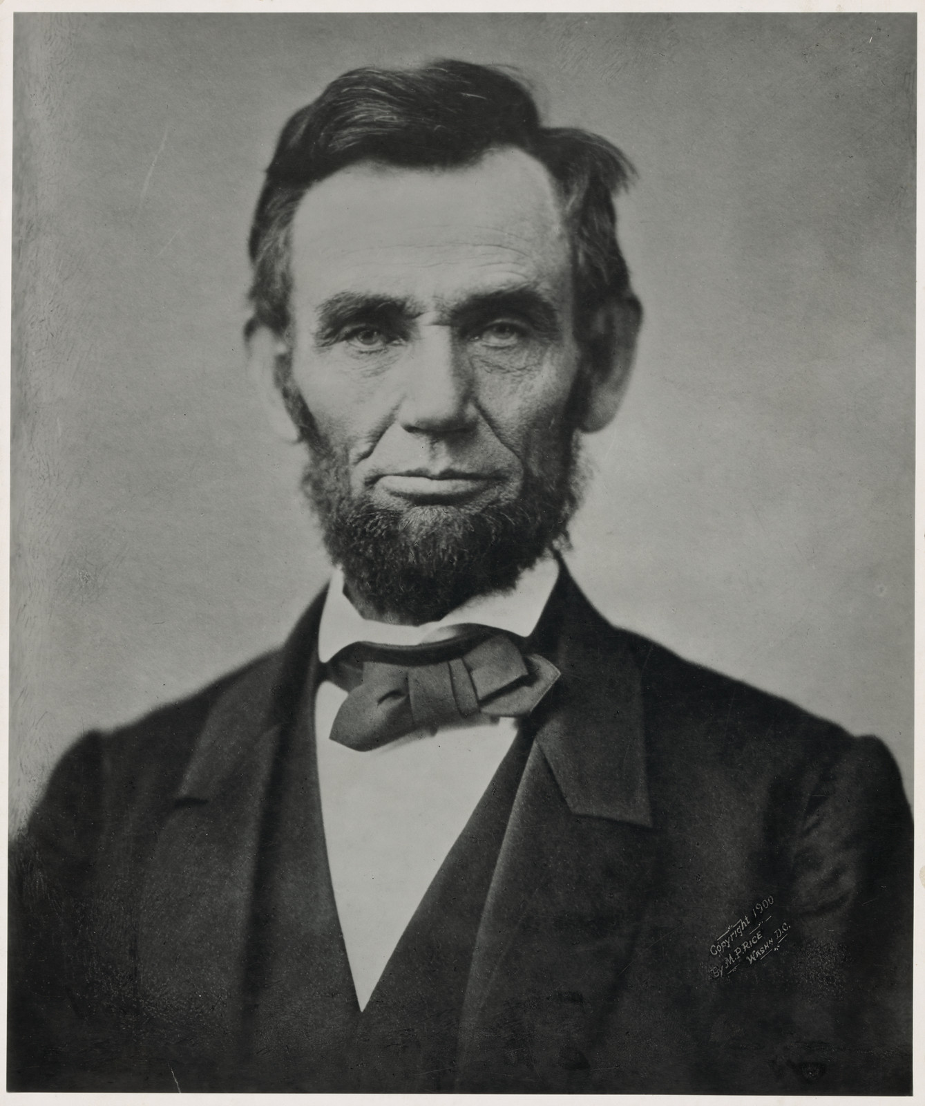 Studio portrait of a bearded man in a bow tie — historic image