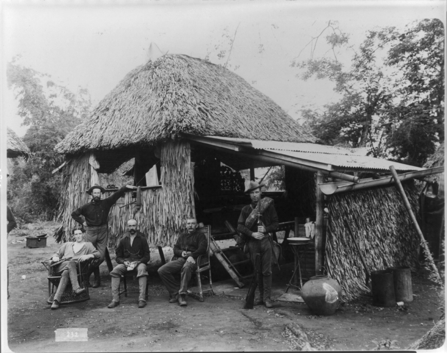 [Five American soldiers in front of thatched hut, Philippines], 1899 — historic photograph