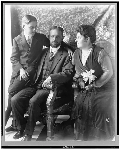 [President Mario Menocal, of Cuba, full-length portrait, seated, facing front, with his wife and son]