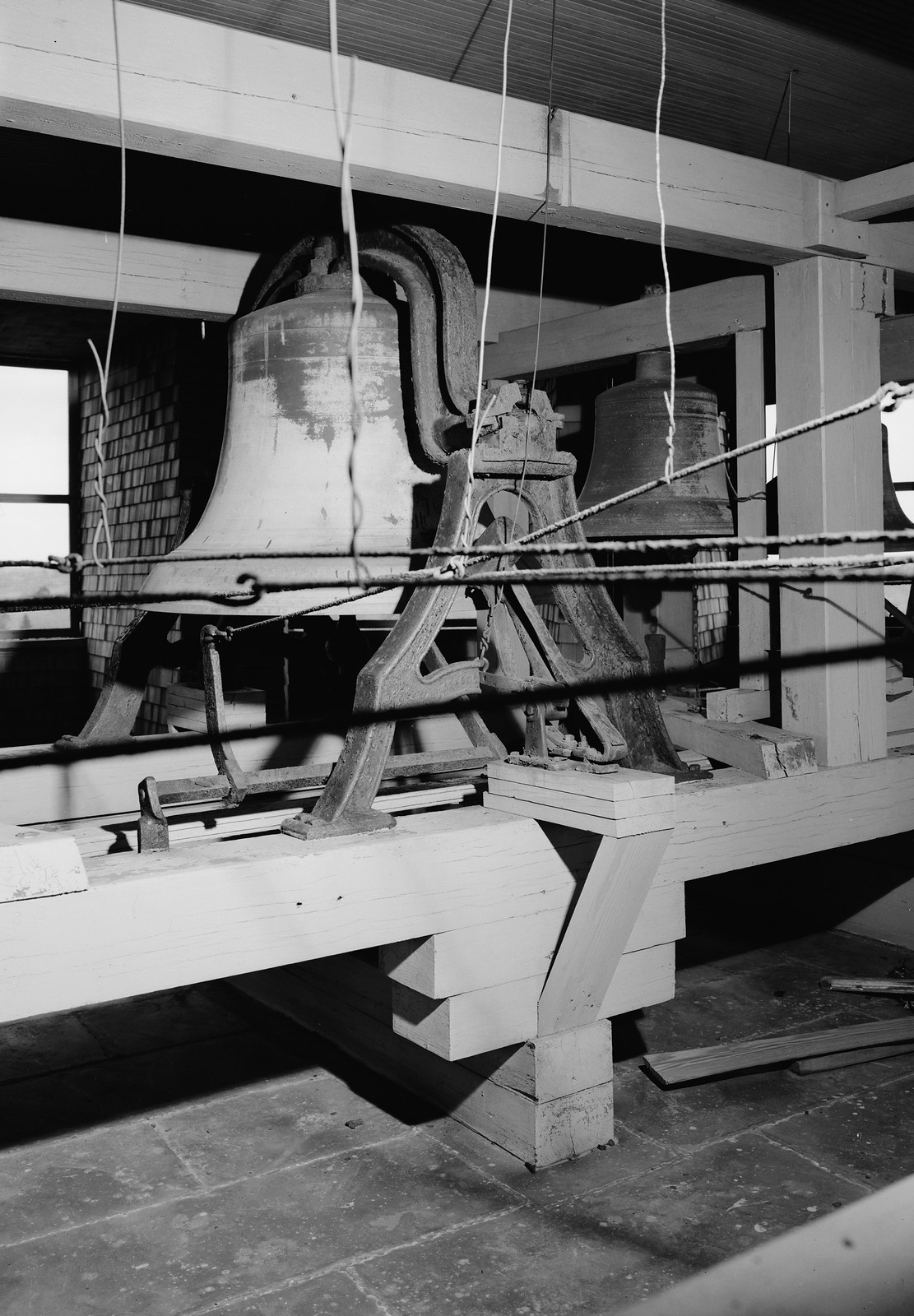 Two church bells mounted in a belfry, black and white photograph — historic photograph