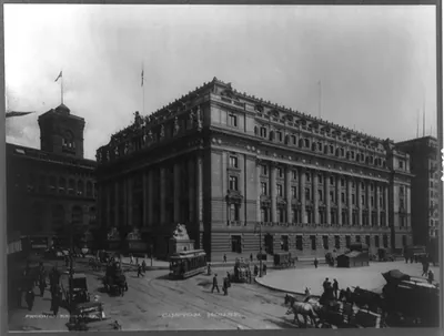 [NYC Custom house. Automobiles, horse-drawn wagons and streetcars on street]