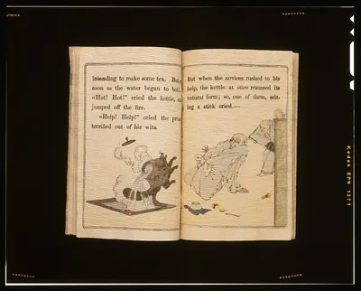 Open illustrated book showing the kettle and tanuki story