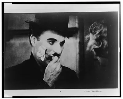 Scene from City Lights: man in bowler hat holding a flower
