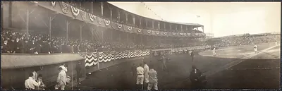 Panoramic view of a baseball park with crowds and bunting