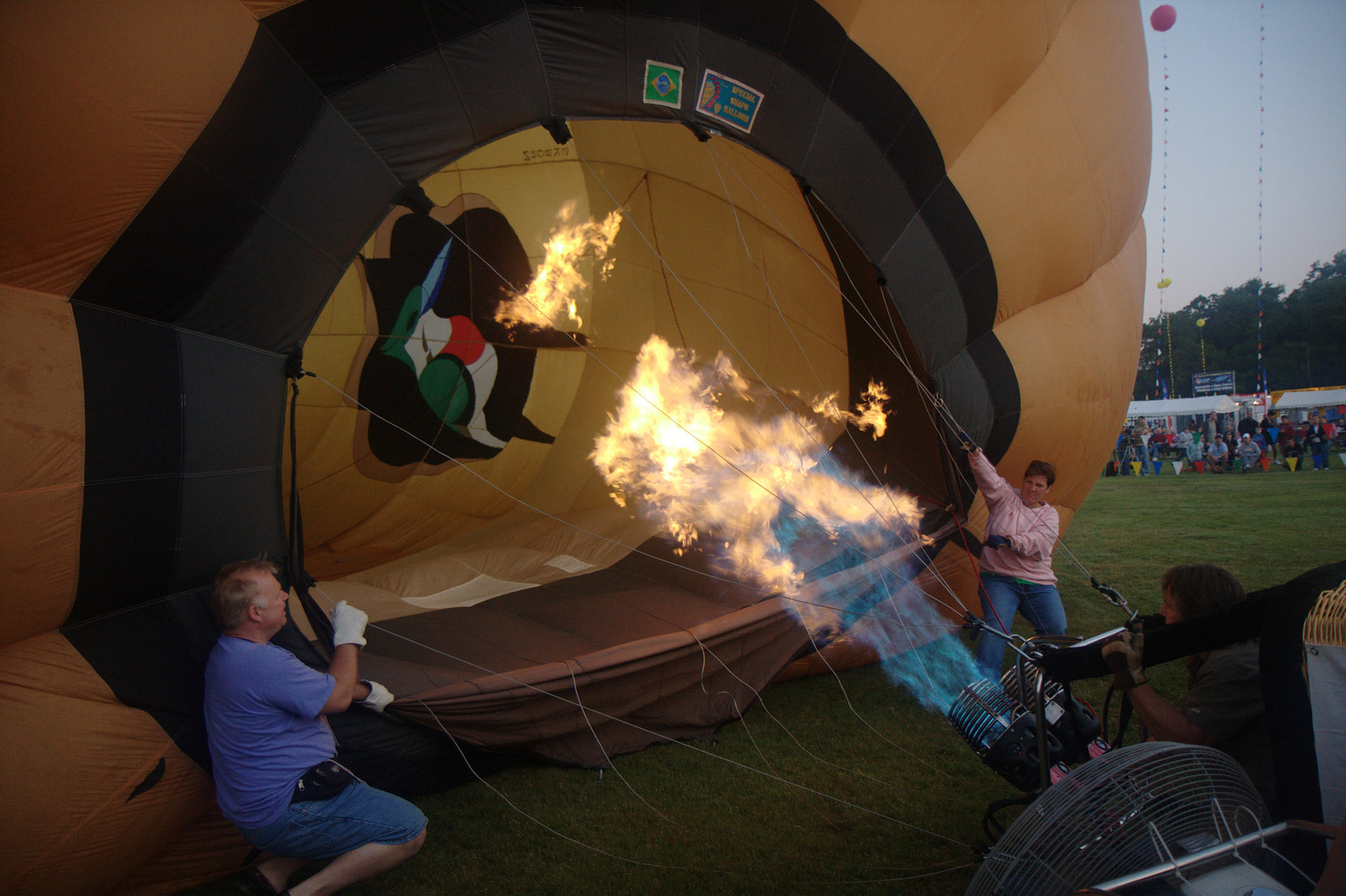 Hot air balloon being inflated with burner flame — historic image