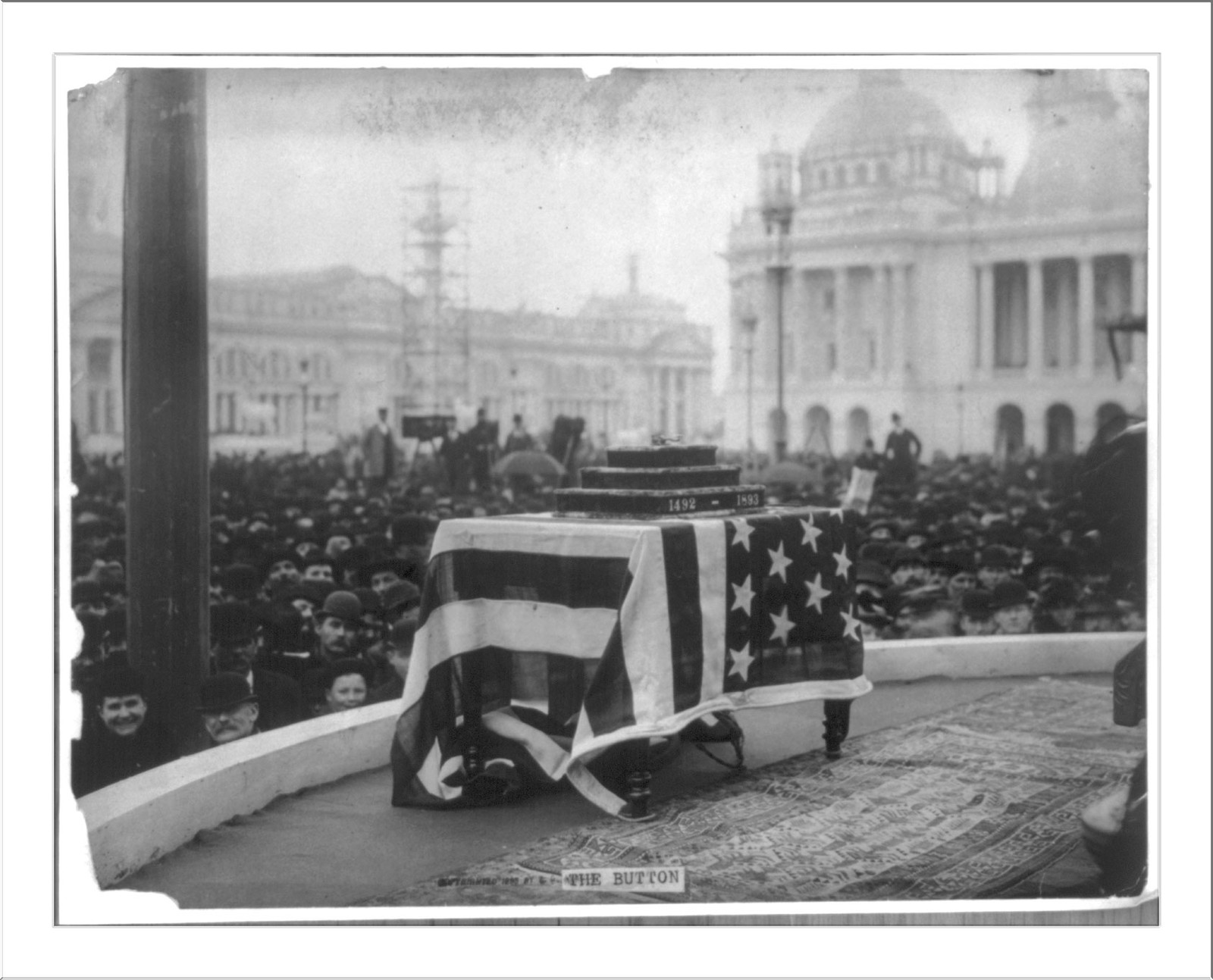 World's Columbian Exposition, Chicago, Ill. May 1, 1893 (opening ceremonies): The Button" [telegraph transmitter?] on flag covered table in front of crowd" — historic photograph