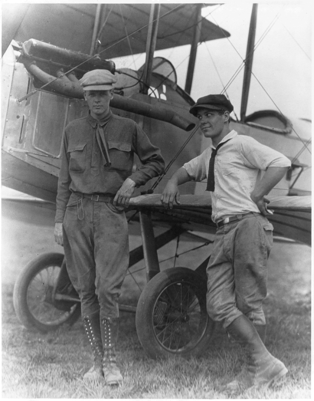 [Lindbergh and Harlan Bud" Gurney standing by plane at Lambert Field Missouri]", 1923, c1928. — historic image