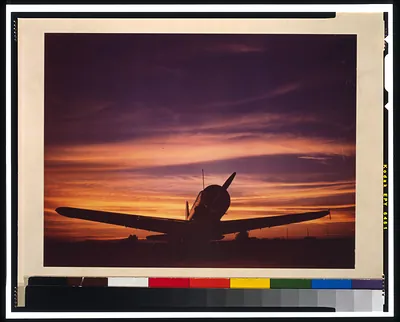 [Military airplane on tarmac at sunset]