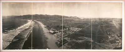 Panoramic aerial view of coastal beach and tent camp