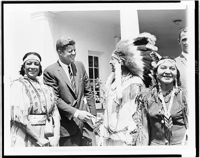 [Calvin H. McGhee and two women of the Creek Nation, confer with President John F. Kennedy, outside the White House]