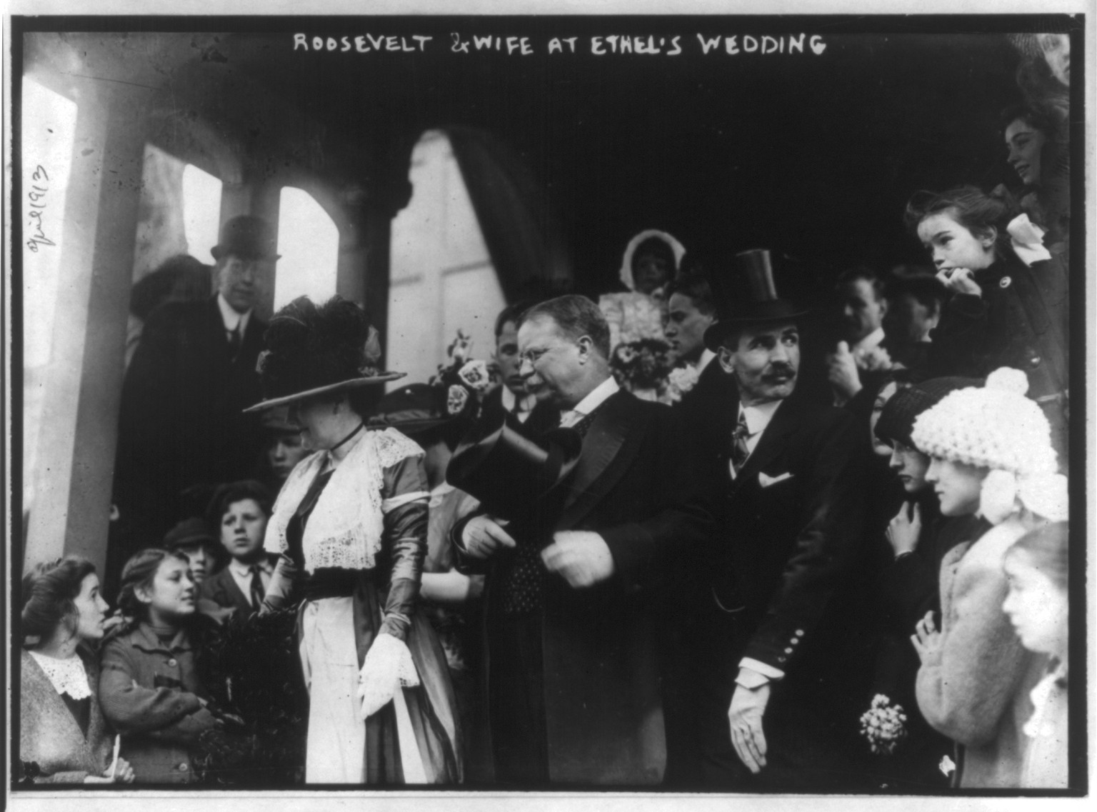 [Theodore Roosevelt, three-quarters, standing on steps, facing left, with wife and others, at Ethel's wedding], 1913 April. — historic photograph