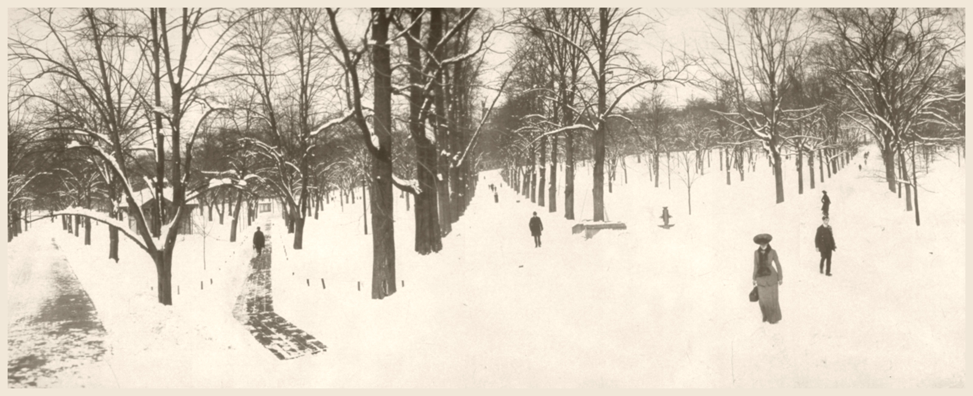 Snow-covered park path with bare trees and walkers — historic image