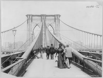[View looking across the Brooklyn Bridge, N.Y.C. with people walking in both directions]