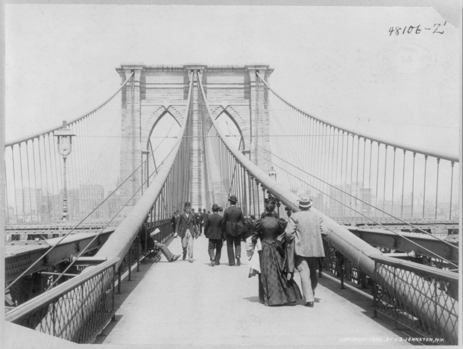 [View looking across the Brooklyn Bridge, N.Y.C. with people walking in both directions], c1894. — historic photograph