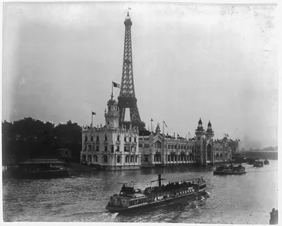 [Pavilion of Portugal at left, Food Products building at right with Eiffel Tower in background and tourist boats on the River Seine, Paris Exposition, 1889]