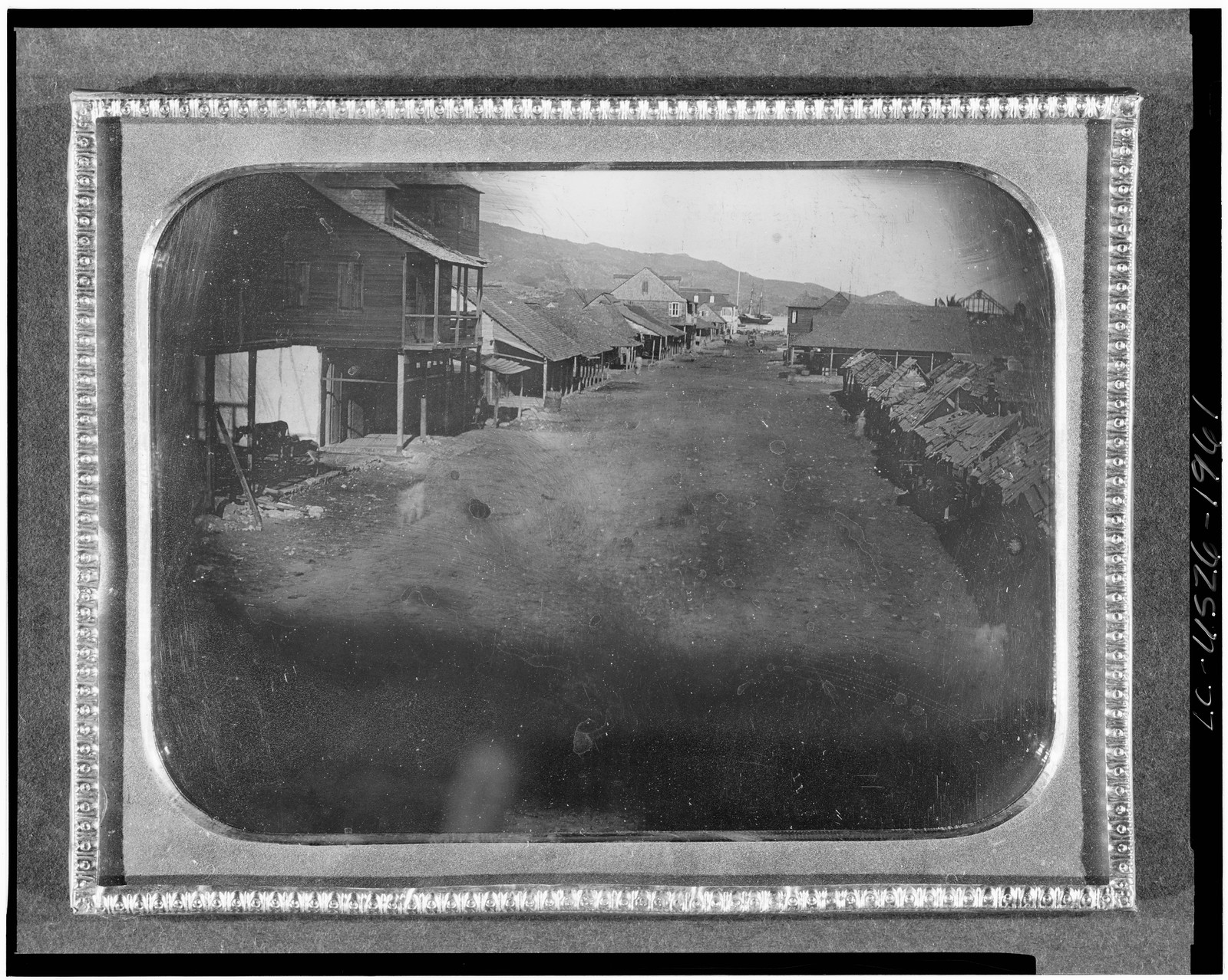 [View of an unidentified village with ship in background], [between 1840 and 1860] — historic photograph